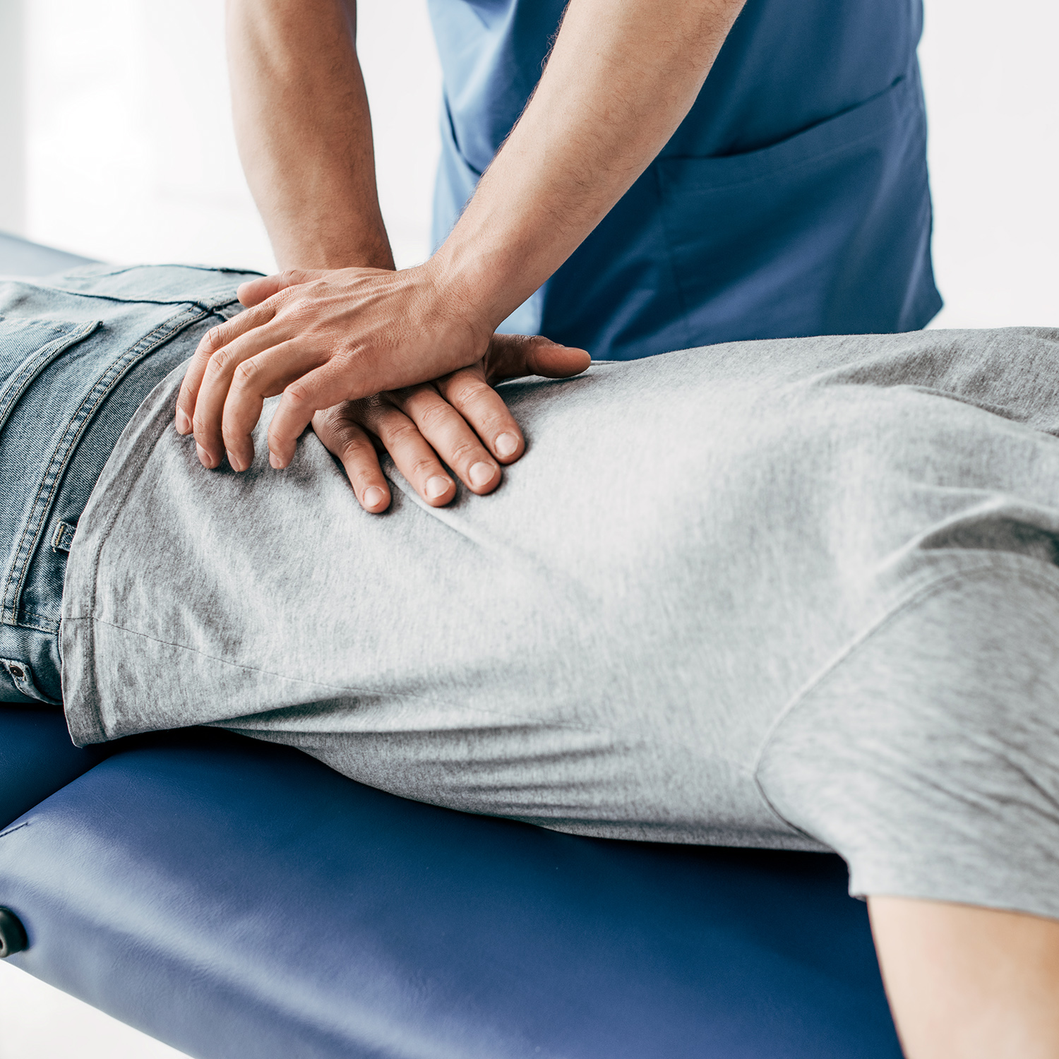 chiropractor massaging back of man on Massage Table in hospital